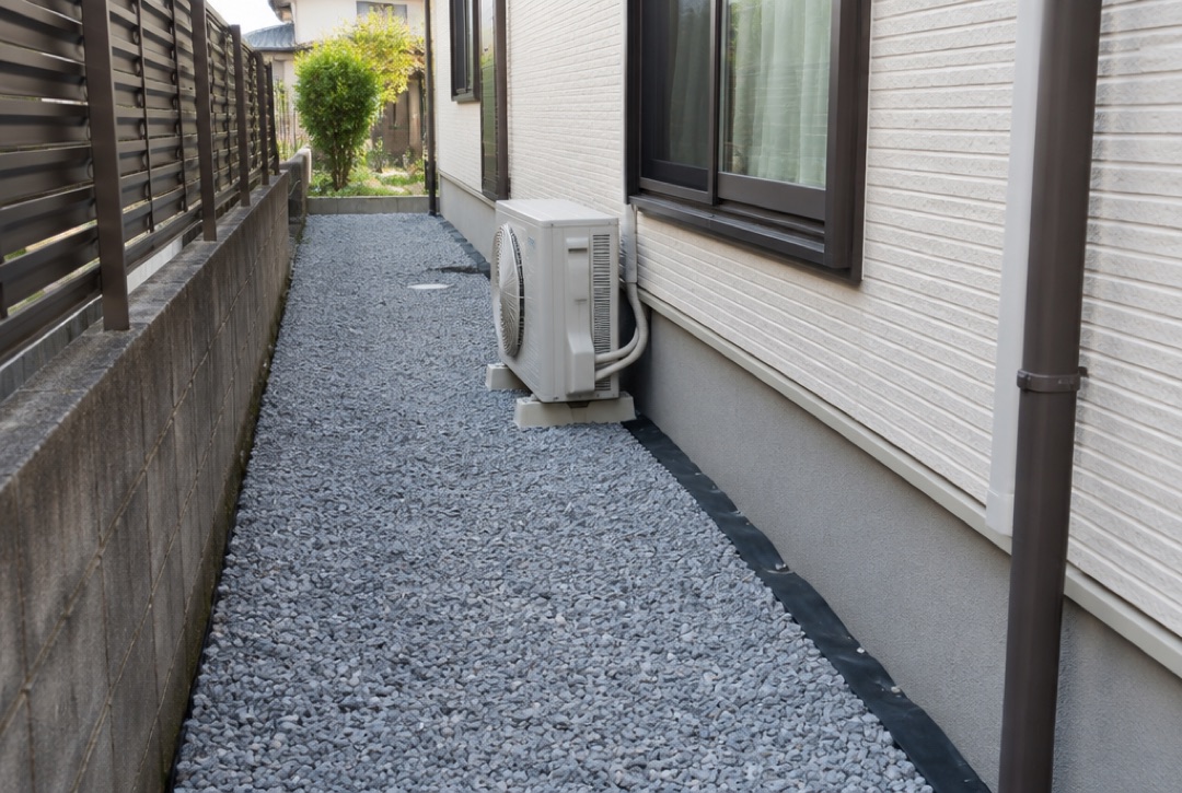 家の横の通路に防草シートと砂利を敷いた様子